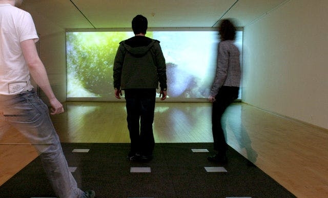 Picture of people looking at video art